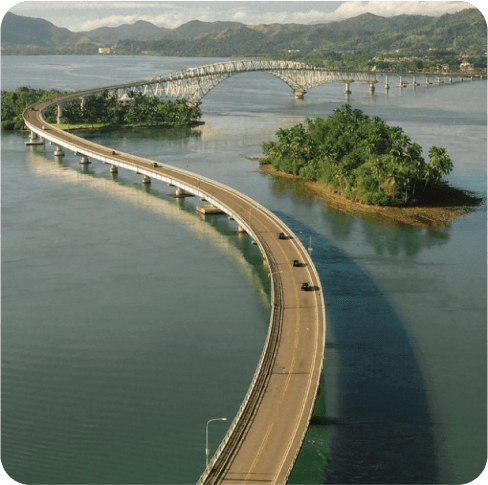 Welcome to San Juanico Bridge.

So call Bridge of Love, an architectural marvel of Leyte! This stunning bridge, built in 1973, connects the islands of Samar and Leyte. Stretching over 2 kilometers, it was the country's longest bridge till 2022.

As a gesture and birthday gift, the San Juanico Bridge stands as a profound testimonial of President Marcos' unwavering love for Imelda.

It is being located near city of Tacloban. If you come to Lintaon Hills by plane, don't miss the chance to witness this engineering wonder that unites communities and offers breathtaking views.